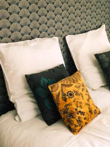a bed with two pillows on it with at Maison d'hôtes La Rose d'Alsace in Rosheim +48 photos