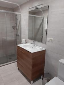 a bathroom with a sink, toilet and bathtub at El Retiro in Nigrán