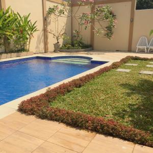 a swimming pool in a house with a yard at Villa Pondok Joglo in Yogyakarta