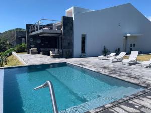 a swimming pool in front of a house at House Rodrigues in Água de Pau
