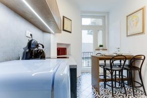 a kitchen with a counter and a table and chairs at Apartment Petrska in Prague