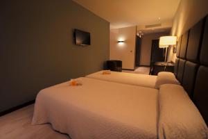 Postel nebo postele na pokoji v ubytování Hotel Torre de Núñez