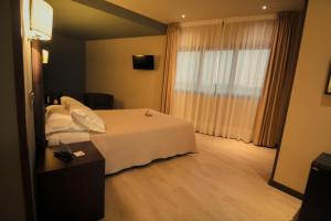 Postel nebo postele na pokoji v ubytování Hotel Torre de Núñez