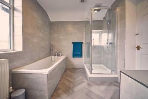 a bathroom with a bath tub and a shower at Host & Stay - Silverlinings in Seaton Delaval