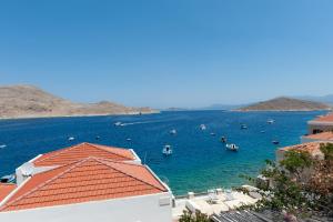 a view of a body of water with boats in it at Atlantis Houses in Halki