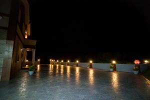 a lit up patio at night with lights on it at Ryan's Guesthouse in Xiyu