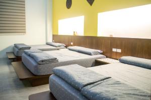 a room with four mattresses lined up in a row at Ryan's Guesthouse in Xiyu