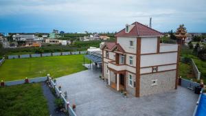 an aerial view of a house with a yard at Ryan's Guesthouse in Xiyu