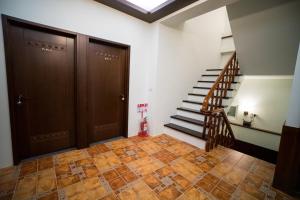 a hallway with two sets of doors and a staircase at Ryan's Guesthouse in Xiyu
