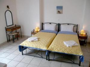 A bed or beds in a room at Apollon Rooms
