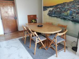 a dining room table and chairs with a view of a harbor at Porto Centrum Apartments in Porto