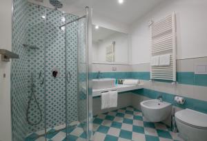 a bathroom with a shower and a toilet and a sink at Hotel Nice in Sorrento