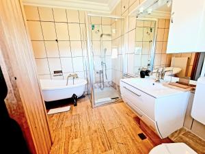 a bathroom with a tub and a shower and a sink at Hotel Elisabeta in Alba Iulia