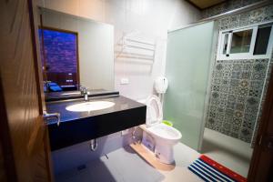 a bathroom with a sink and a toilet at Ryan's Guesthouse in Xiyu