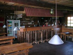 a restaurant with a bar with a light hanging from the ceiling at Kalda Talu in Tõlliste