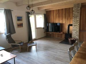 a living room with a flat screen tv and a couch at Apartmán Nežichov in Toužim