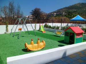 a playground with a toy car and a swing at Residence Soleluna in Praia a Mare