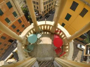 an overhead view of a spiral staircase in a building at Victoria House Hostel in Genoa