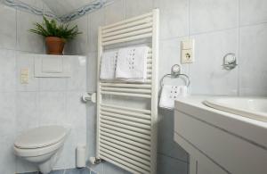 a white bathroom with a toilet and a sink at Ferienhaus Mehlhartl in Tamsweg