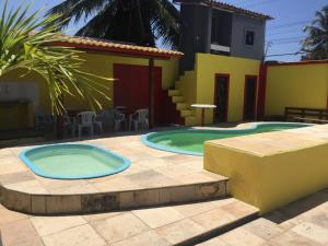 a swimming pool in a patio with a house at Top Home Pousada in Caucaia