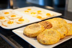 two plates of eggs and biscuits on a table at Spirit Hotel Gran Bilbao in Bilbao