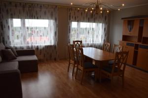 a living room with a table and chairs and a couch at Uma Kuup Guest Apartments in Võru