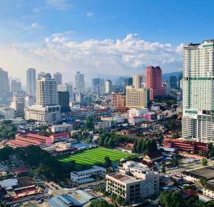 an aerial view of a city with a green field at KLCC One Bedroom apt & Studio in Kuala Lumpur