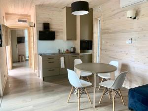 a kitchen and dining room with a table and chairs at OkejAparts in Wilkasy