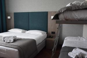 a bedroom with two bunk beds and a ladder at Hotel Motel Prestige in Grugliasco