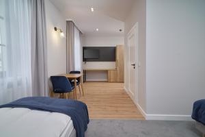 Posteľ alebo postele v izbe v ubytovaní Apartamenty Queen