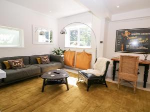 a living room with a couch and a table at Kub House in Tring