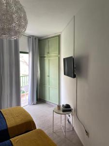 1 dormitorio con 1 cama y TV en la pared en Apartamentos Eva y Lola, en Valle Gran Rey