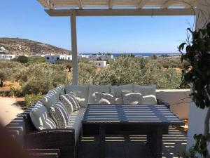 a patio with a couch and a table with a view at Villa Perivoli in Platis Gialos