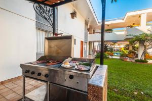 a barbecue grill with food on it in a backyard at Hotel Isabel in Guadalajara