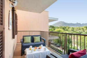 a balcony with two chairs and a table at Tamarels beach apartment in Pollensa in Pollença