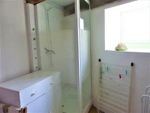 a glass shower in a bathroom with a dresser at Maison cosy séjour découverte mer et campagne in Saint-Caradec-Trégomel +29 photos