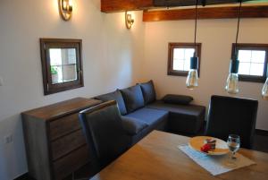 a living room with a couch and a table at Vorgova klet in Bogojina