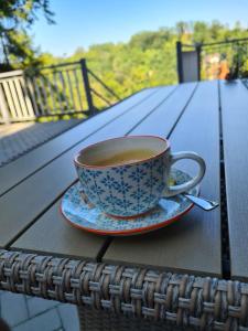 a cup of coffee on a plate on a table at Vila Niki in Sovata