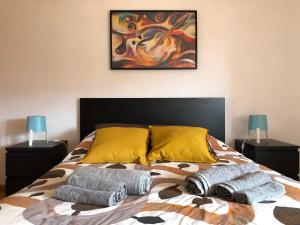 a bedroom with a bed with two pillows on it at Casinha Minhota in Eirado
