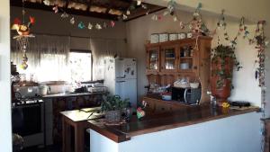 a kitchen with a counter top and a refrigerator at Poente Guest House in Conceição da Ibitipoca