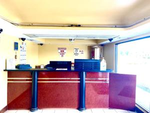 a bar in a restaurant with a red and purple at REGENCY INN in Orlando