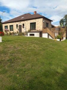 a house with a large lawn in front of it at B&B Sandra in Alūksne
