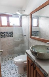 e bagno con servizi igienici, lavandino e doccia. di Apartamento Madeiro a Villa de Leyva