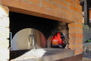 a brick oven with a red bag sitting in it at Apartma PEPI in Rogaška Slatina