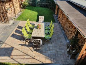a wooden table and chairs on a patio at Gute Laune Hof Klingenthal in Klingenthal