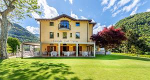 a large house with a lawn in front of it at Locanda Sant' Anna in Argegno