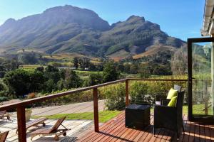 a balcony with a view of a mountain at Alluvia Boutique Winery & Luxury Accommodation in Stellenbosch
