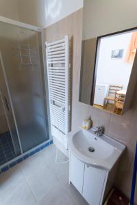 a bathroom with a shower and a sink and a mirror at Apartmány Bowling Frýdlant in Frýdlant