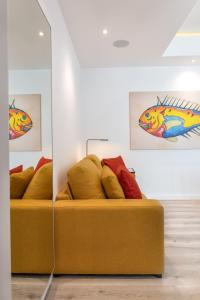 two beds in a room with paintings on the wall at Lauser City Suites in Los Llanos de Aridane