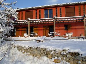 a house with snow on the ground in front of it at Maison Rouge in Plan dʼAups